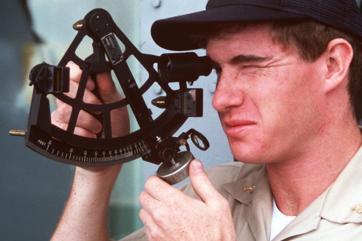 A US Navy midshipman taking a sextant reading as part of his training