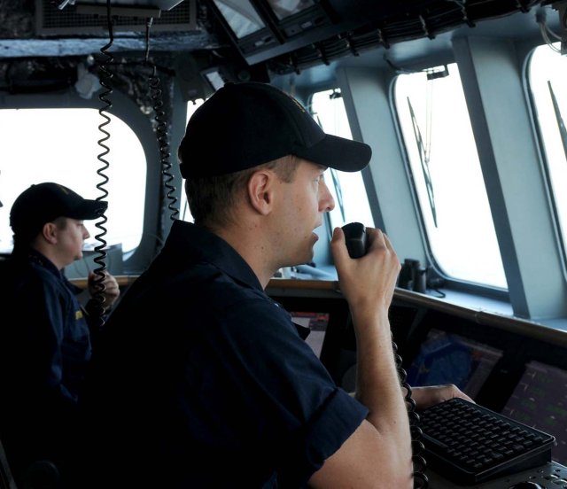 A U.S. Navy bridge officer using VHF radio on the USS Independence