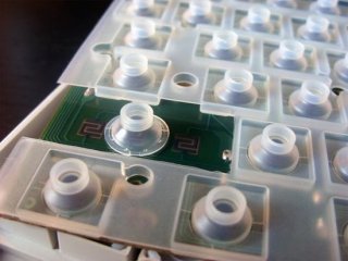 Rubber domes positioned over a keyboard matrix PCB